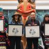 Four Indigenous leaders holding framed awards on stage